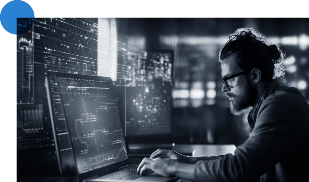 engineer sitting in front of multiple monitors focused on technical work