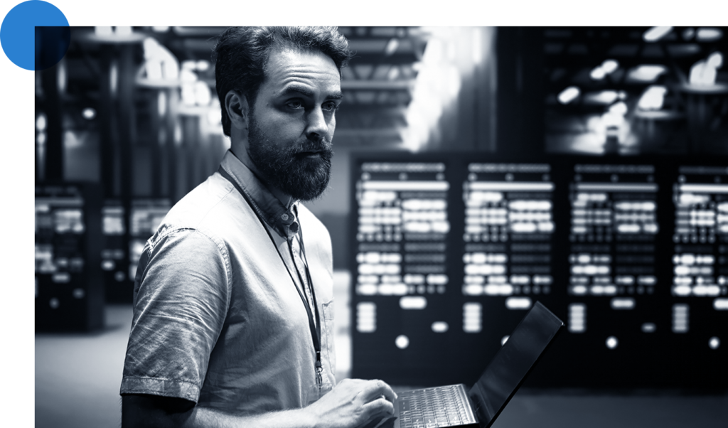 Data center engineer looking over servers in racks